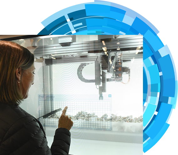 A woman is pointing a product showcase on the show floor.