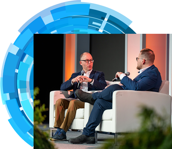 Two men on stage having conversation
